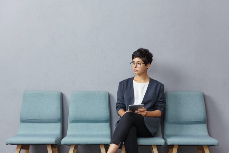 Horizontal portrait of young attractive woman being in anticipation of meeting with potential partne